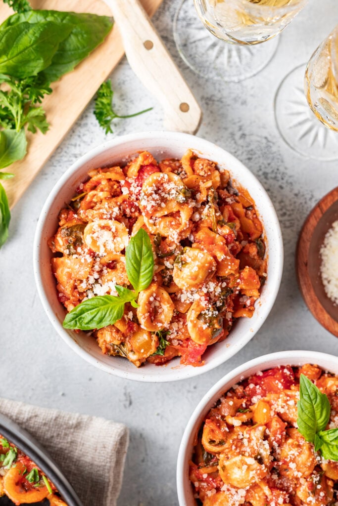 cooked pasta in a bowl with cheese and sauce