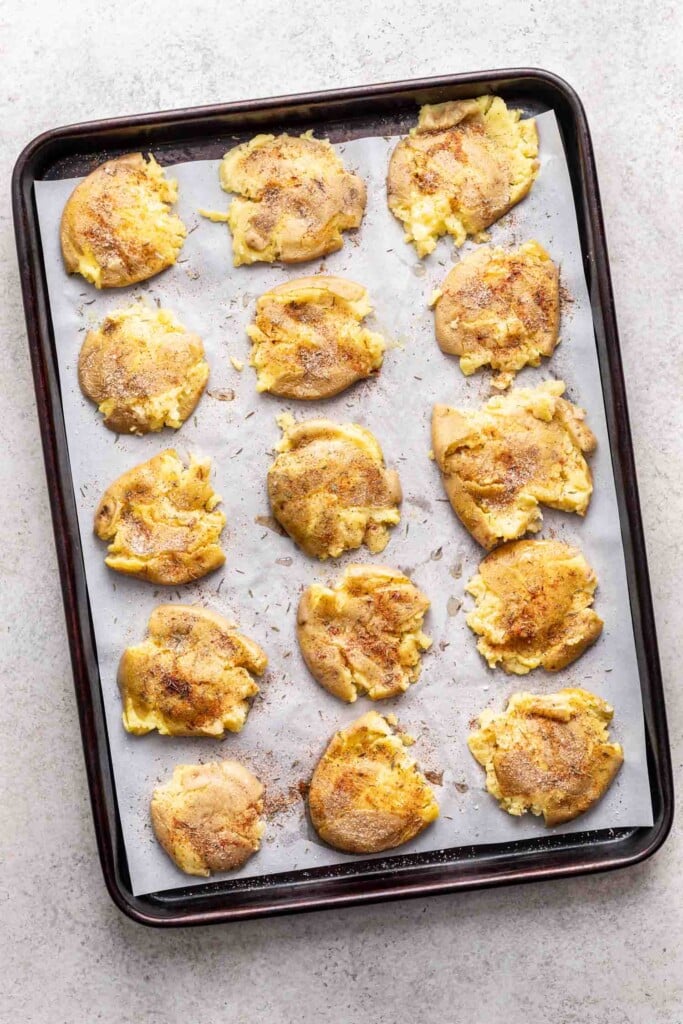 smashed baby potatoes on a sheet pan