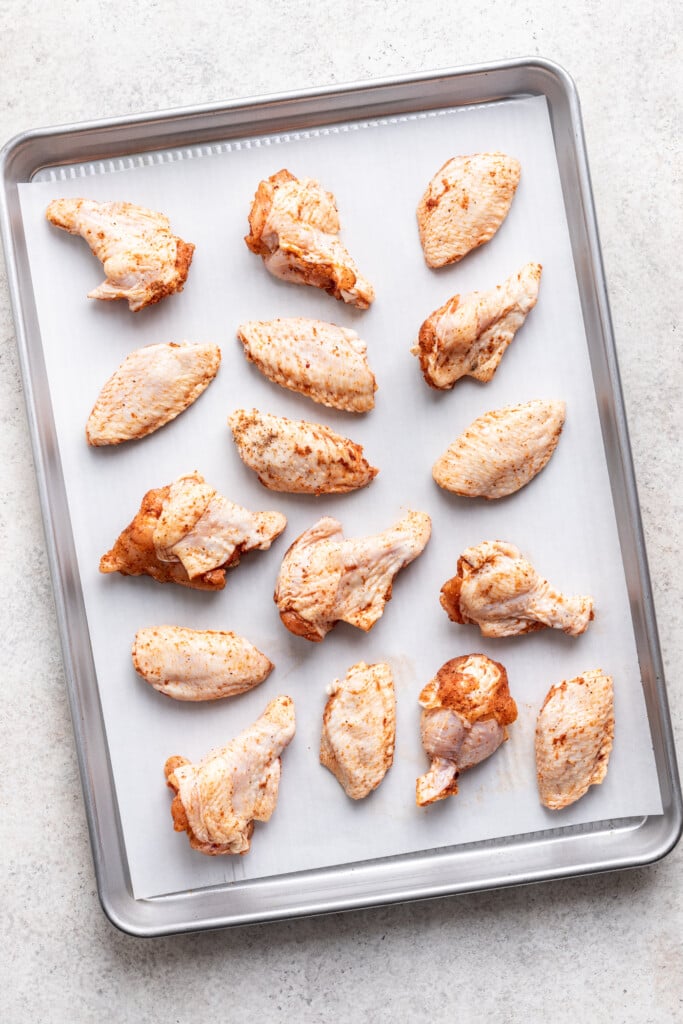 chicken wings on a parchment lined sheet pan