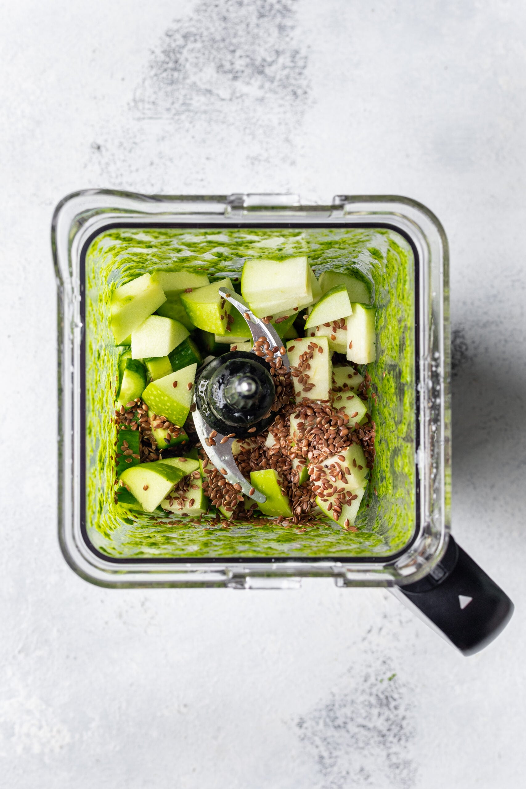 green smoothie ingredients in a blender