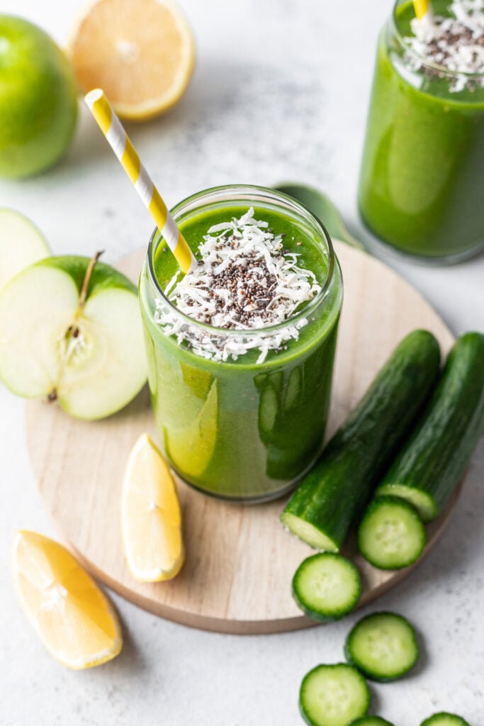 green smoothie with coconut flakes and chia seeds on top