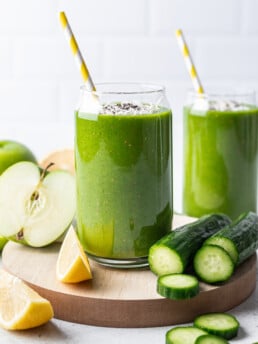 green smoothie in a glass with a yellow straw