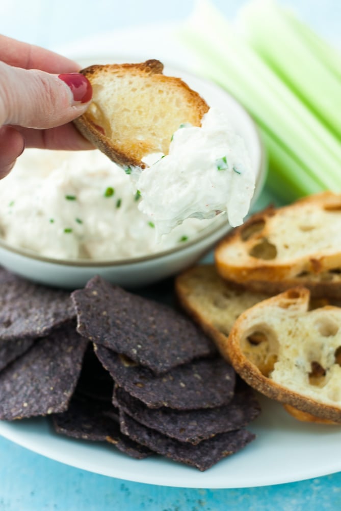 crostini dipped in crab dip