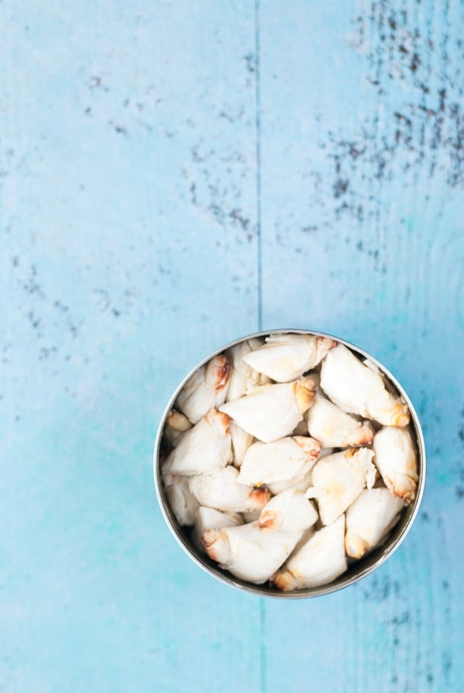 lump crab meat in a can on a blue background