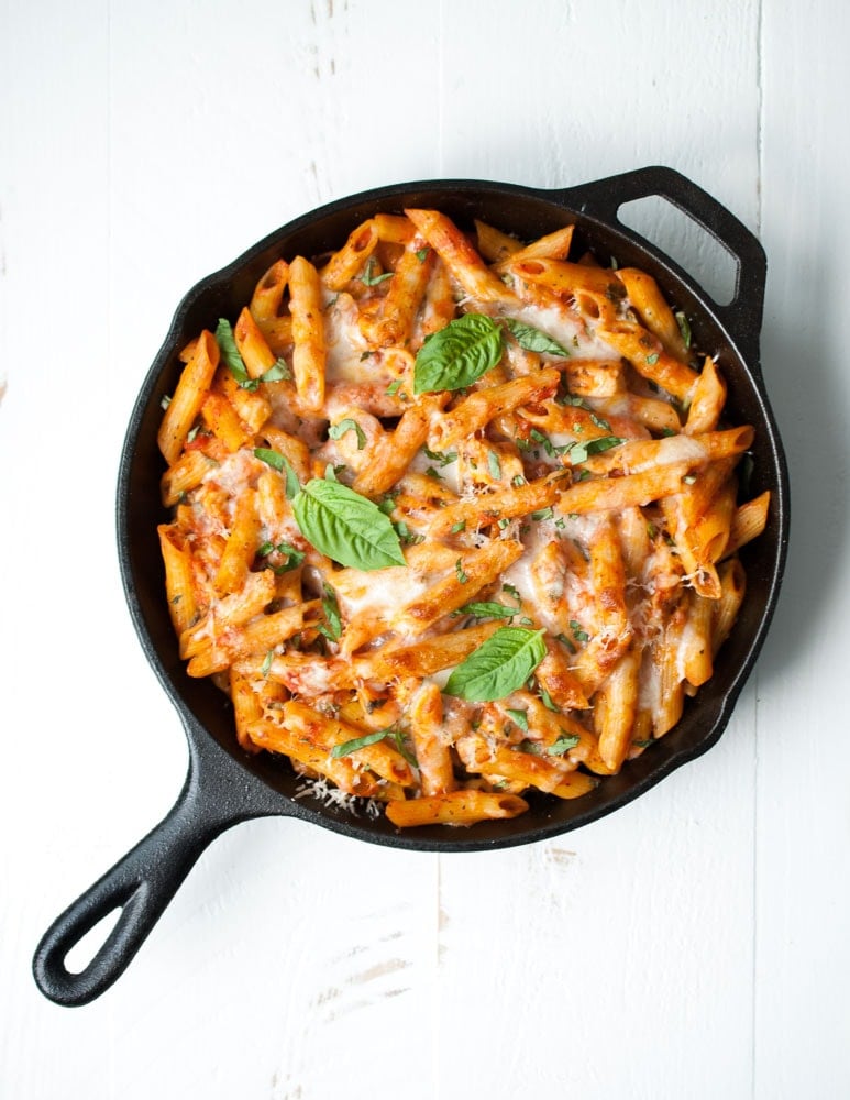 a cast iron skillet with cheesy baked ziti