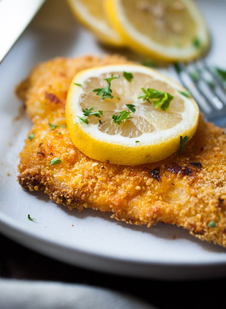 breaded chicken cutlet with lemon slice on top
