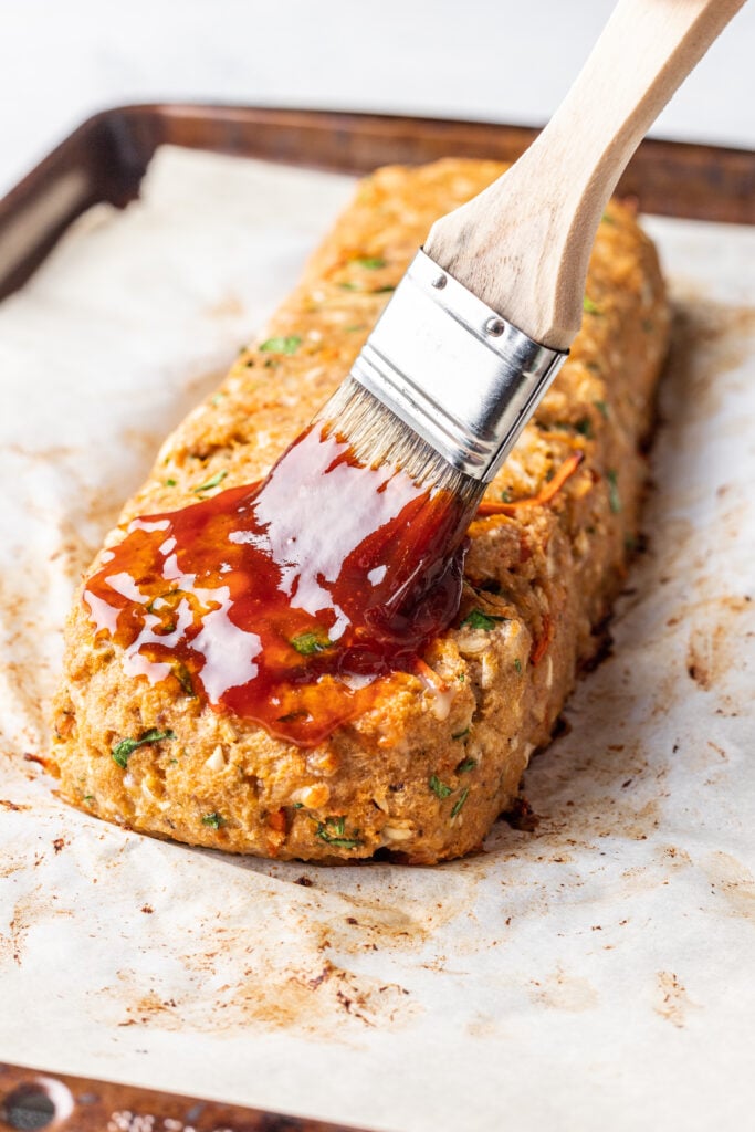 glaze being brushed over turkey meatloaf