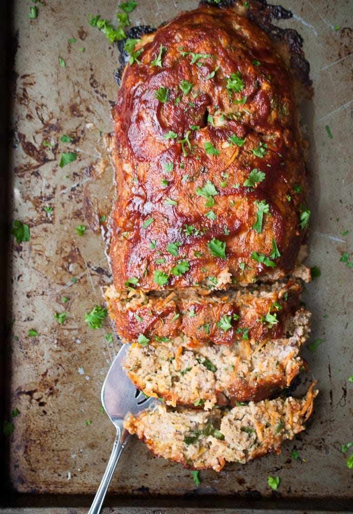 Turkey Meatloaf sliced on a sheet pan with spatula