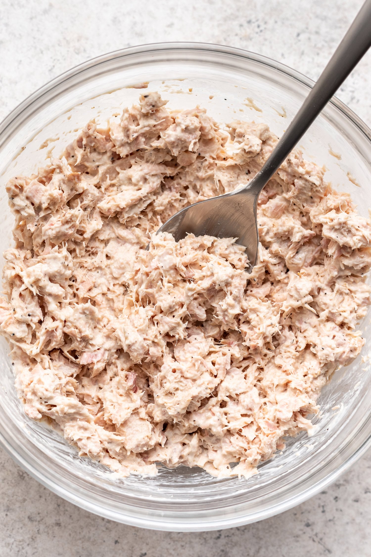 tuna salad in a glass bowl with a spoon