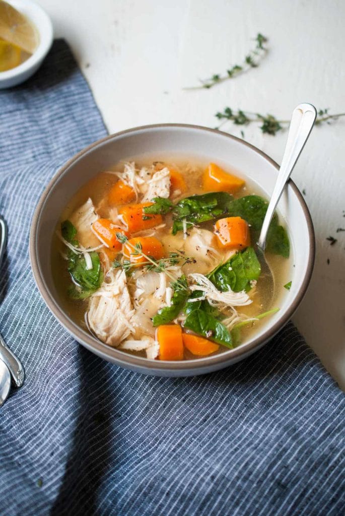 Chicken soup in a bowl with a spoon