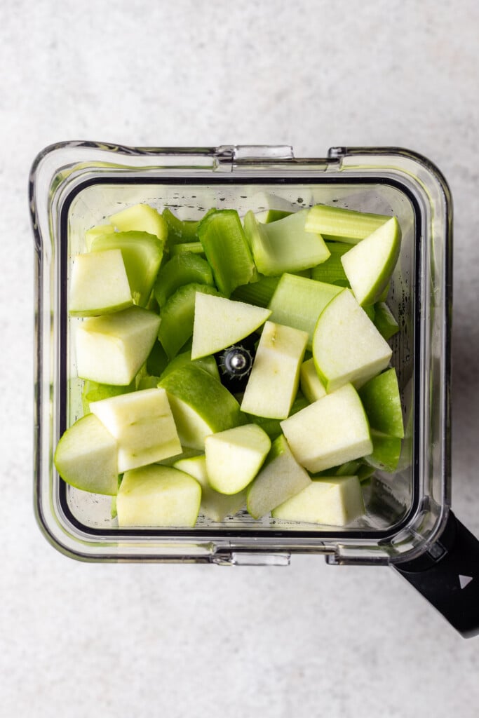 chopped apples, cucumber and celery in a blender