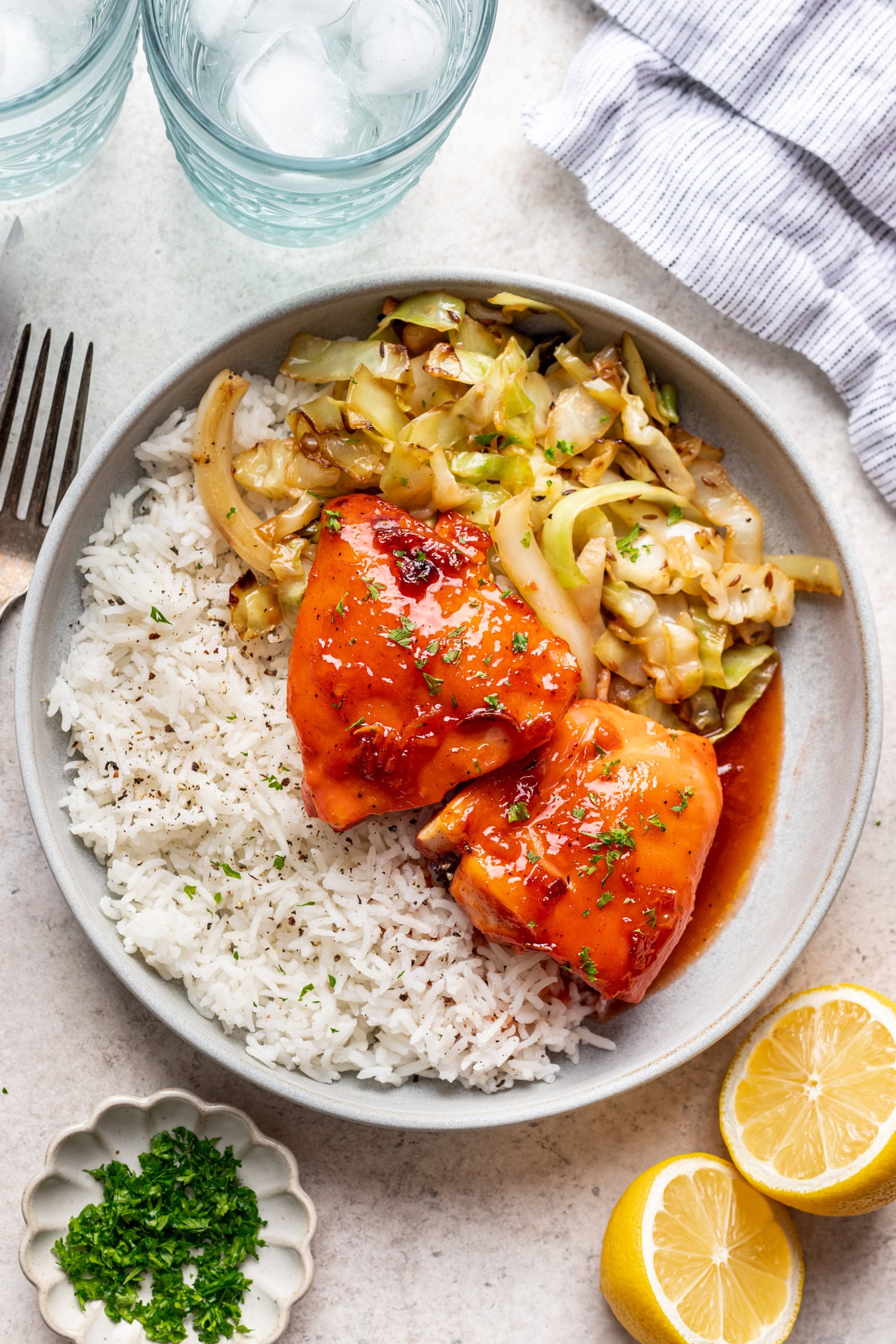 white plate with chicken, veggies and rice
