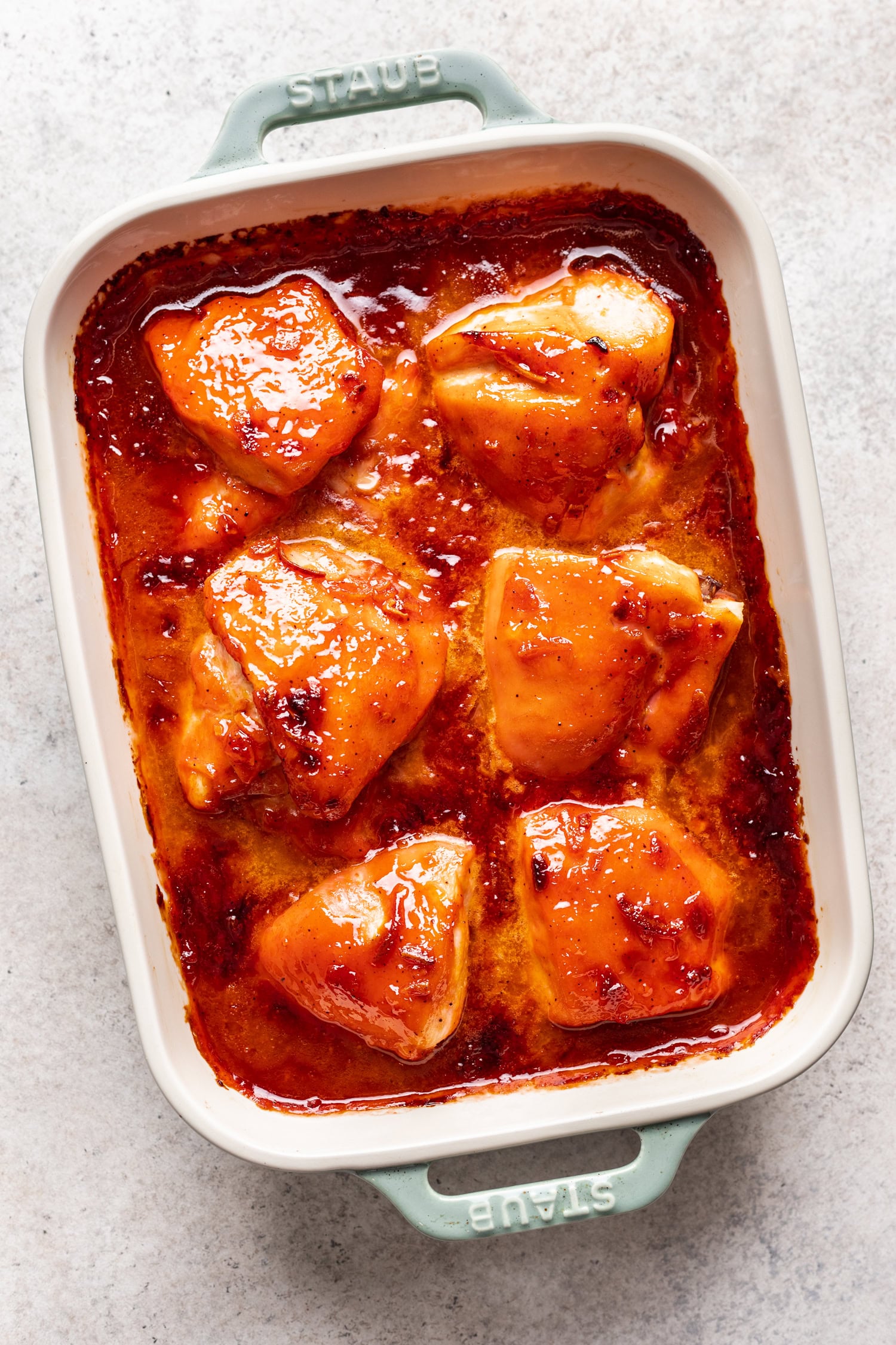 baked chicken pieces in a white baking dish