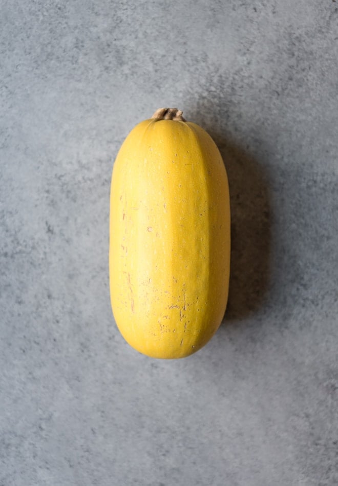 Overhead shot of spaghetti squash on a grey background
