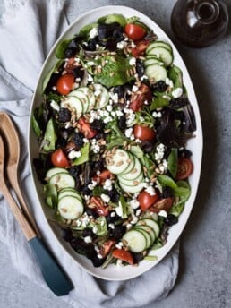 spring mix salad on a white platter