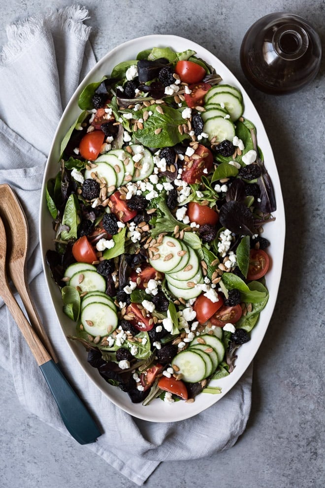 spring mix salad on a white platter