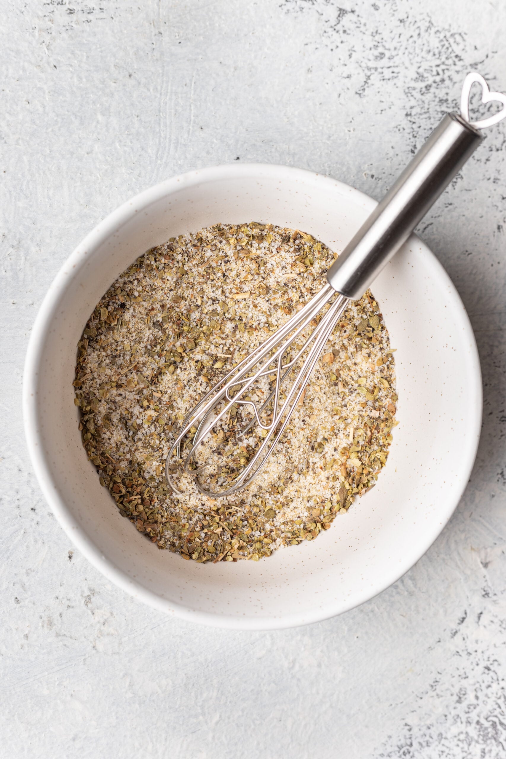 bowl of spices mixed with a whisk