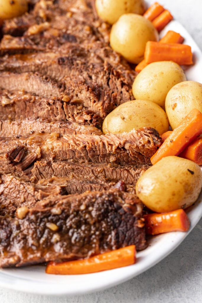 sliced slow cooker brisket with carrots and potatoes