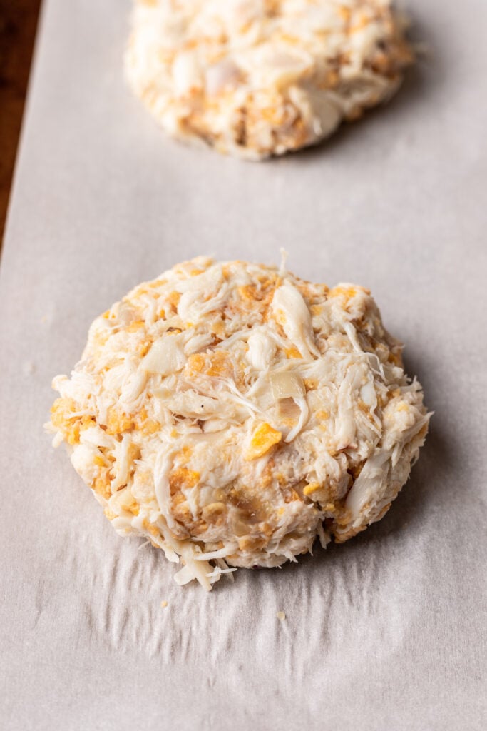 uncooked crab cake on a baking sheet