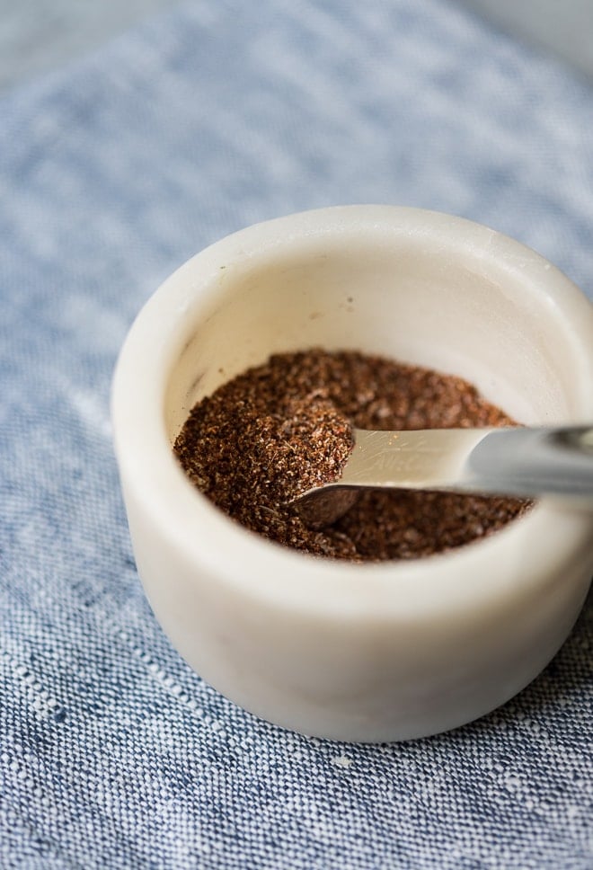 spices in a small bowl with a measuring spoon