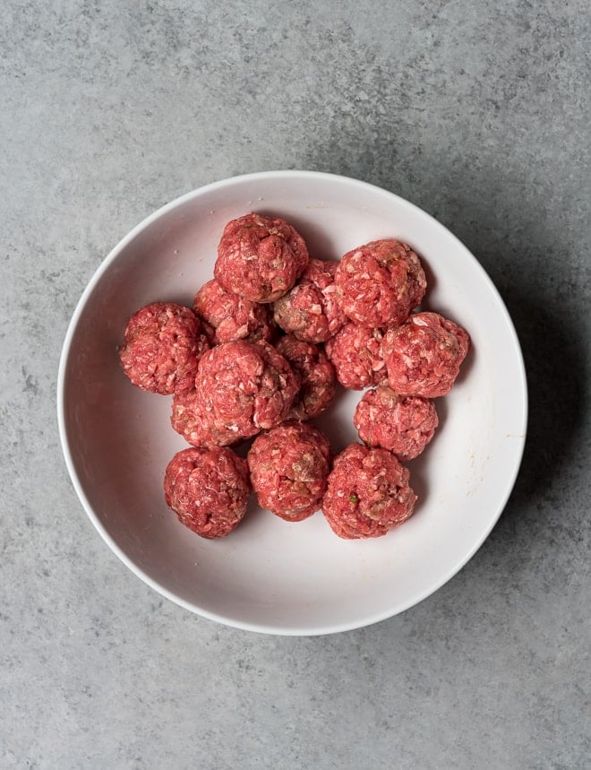 raw meatballs in a white bowl