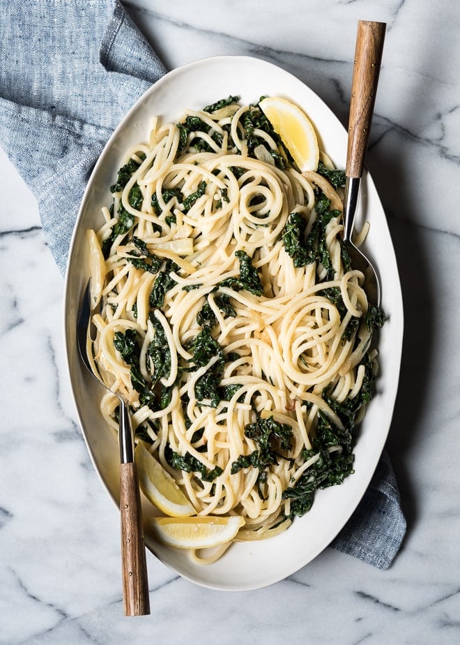 Lemony Pasta with Kale and Parmesan on a platter with a serving spoon
