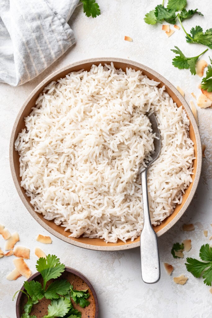 coconut rice in a bowl with a spoon