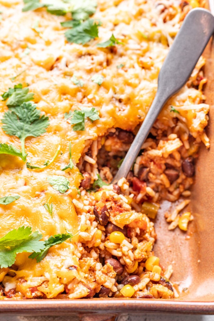 a spoon scooping taco bake out of dish