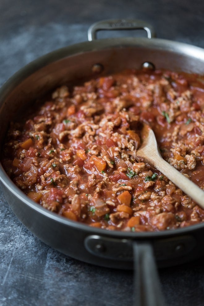 turkey bolognese in a pan with a wooden spoon