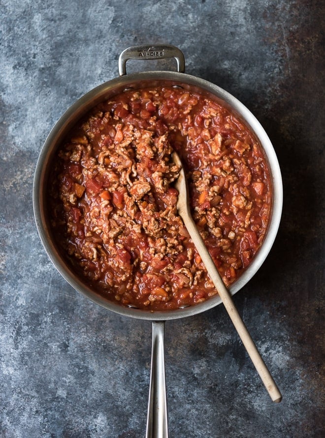 turkey bolognese in a pan with a wooden spoon