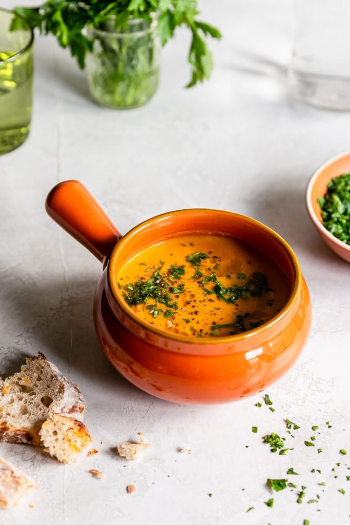 fresh carrot soup in an orange mug