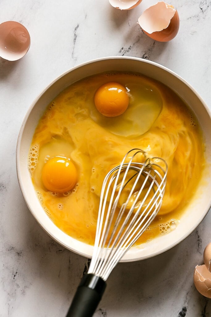 eggs being whisked in a bowl