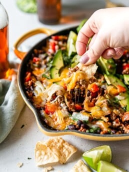 turkey taco skillet being scooped with a chip