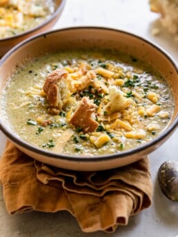 broccoli cheddar soup close up with croutons on top