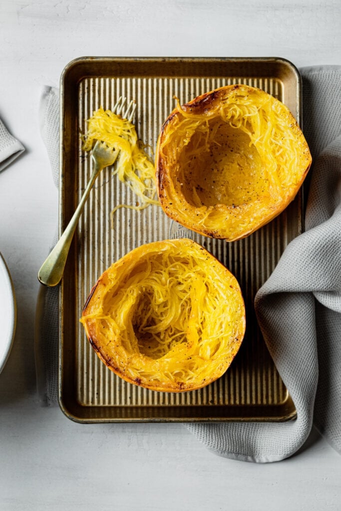 two spaghetti squash halves with a fork