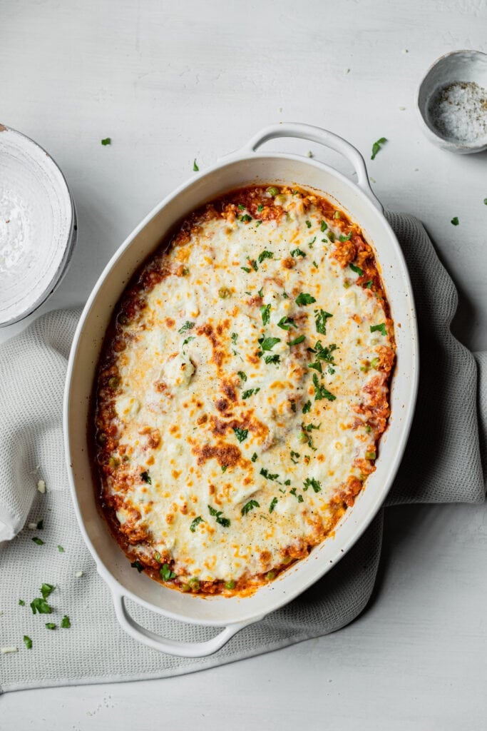 baked spaghetti squash in a casserole dish with melted cheese