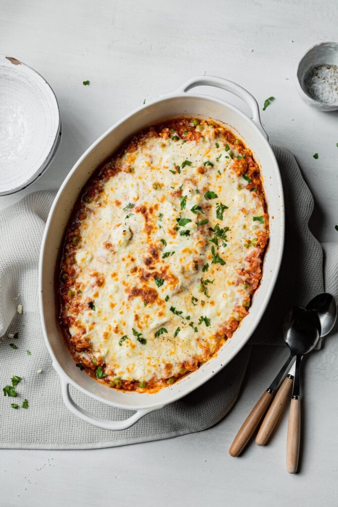 a white baking dish with cheesy spaghetti squash
