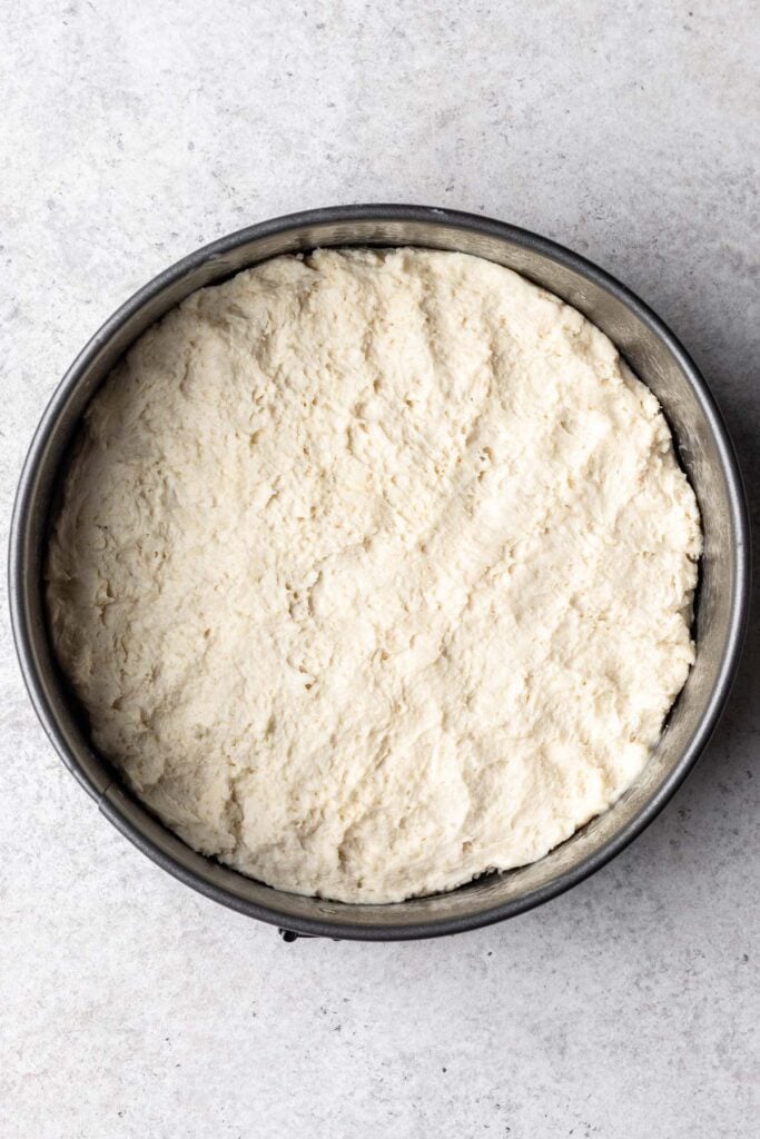 shortcake dough pressed into a round cake pan