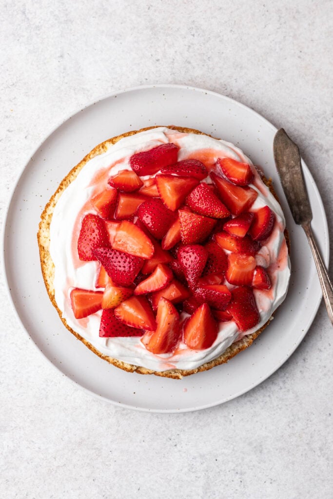 strawberries on whipped cream on a cake