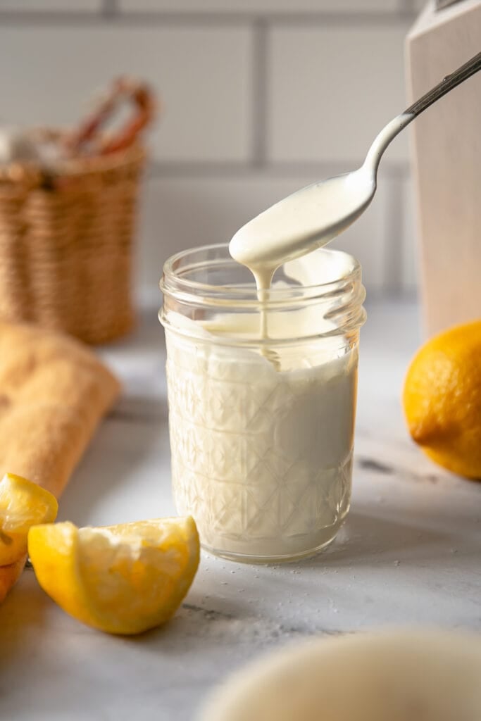 Spoon with Creamy Lemon Mayo Crab Cake Dipping Sauce in a Jar