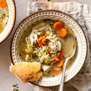 Shredded Chicken and Rice Soup in a Bowl with Slice of Bread