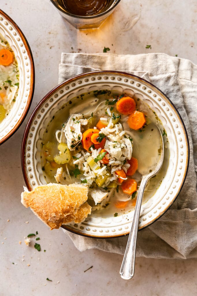 Shredded Chicken and Rice Soup in a Bowl with Slice of Bread