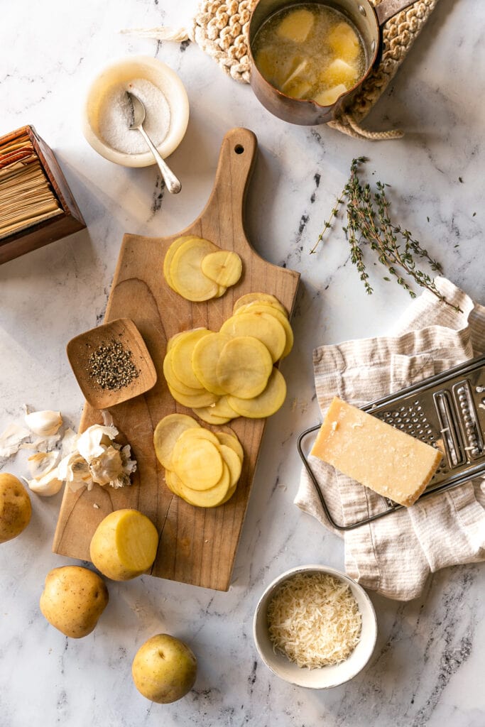 sliced potatoes on a cutting board on countertop