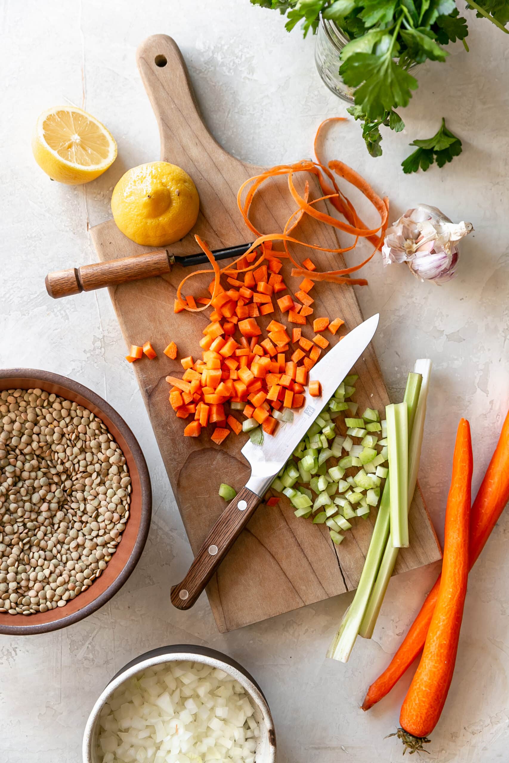 Easy Stovetop Lentil Soup Ingredients on Cutting Board with a Knife