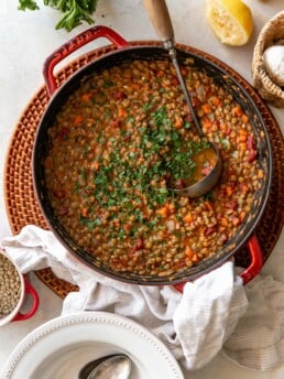 Easy Stove Top Lentil Soup in Red Pot with Ladle and Bowls