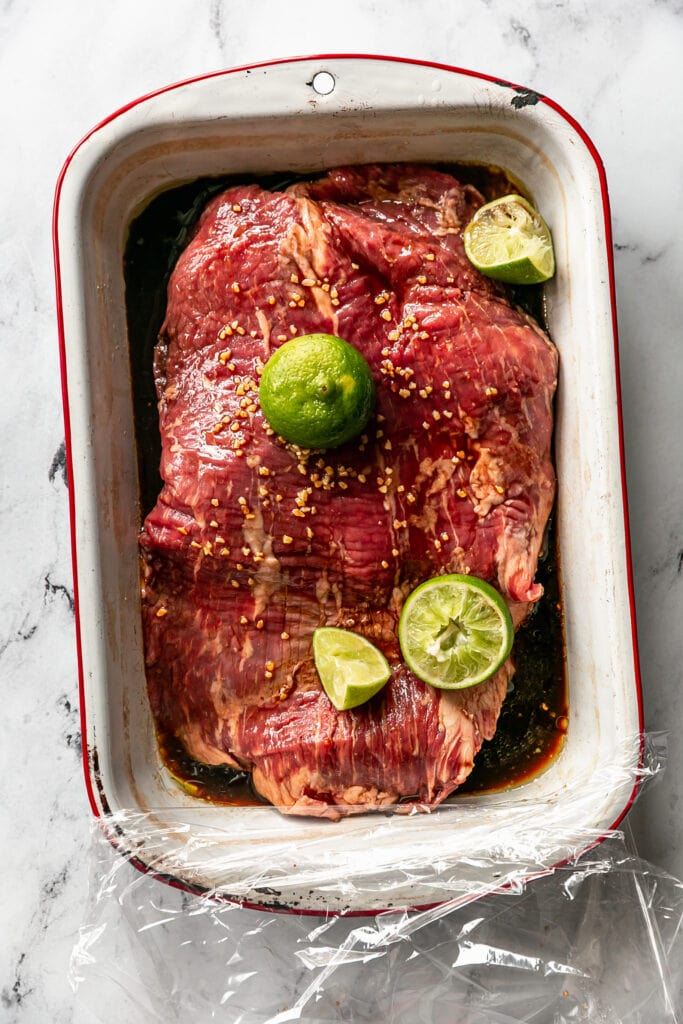 Steak Marinading in Dish with Limes