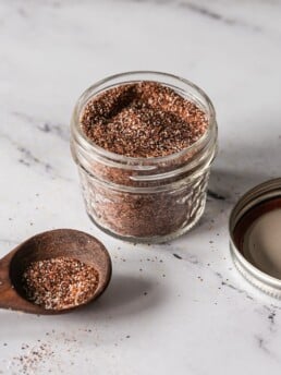 Homemade Taco Seasoning Mild: Taco seasoning spices in a glass jar on a marble countertop