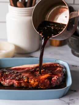 The Best Balsamic Steak Marinade - pouring marinade onto steak