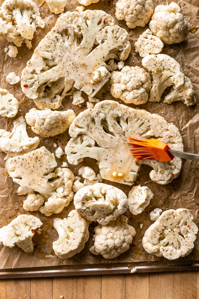 Cauliflower Steaks with Tomato Garlic Confit - cauliflower slices on sheet pan with brushed olive oil, salt and pepper