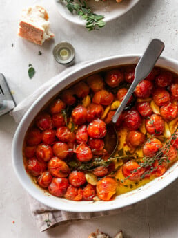 Quick Tomato and Garlic Confit - Roasted Cherry Tomatoes, Herbs and Garlic with Spoon and Torn Bread